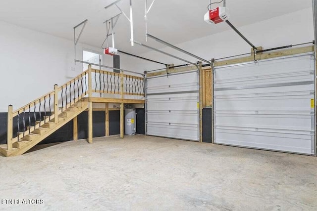 garage featuring water heater and a garage door opener