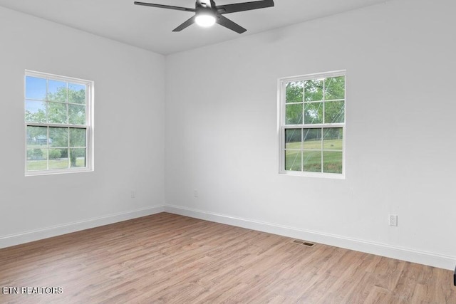 spare room with light hardwood / wood-style flooring and ceiling fan