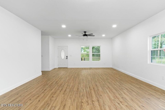 unfurnished living room featuring ceiling fan and light hardwood / wood-style flooring