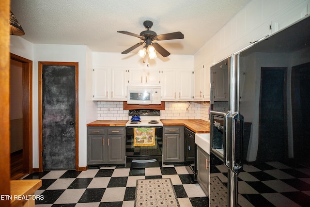 kitchen featuring black fridge, electric range oven, gray cabinets, white cabinets, and backsplash