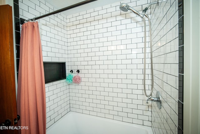 bathroom with shower / bath combination with curtain