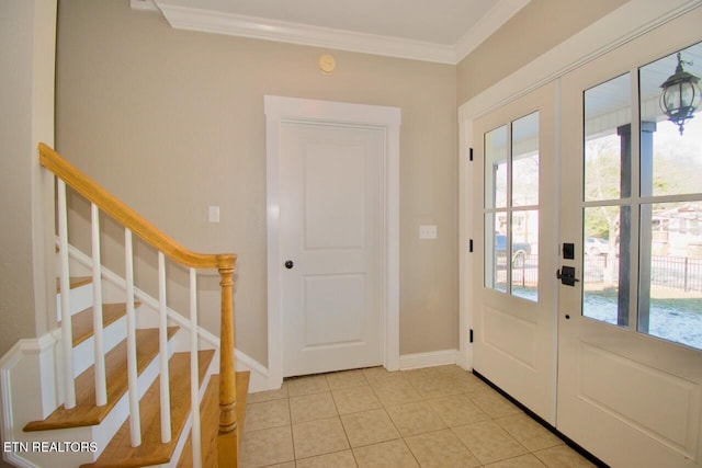 entryway featuring ornamental molding, french doors, and light tile patterned flooring