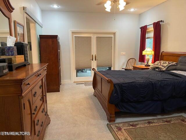 bedroom featuring light carpet, recessed lighting, a ceiling fan, and french doors