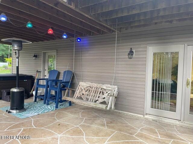 view of patio / terrace with a hot tub