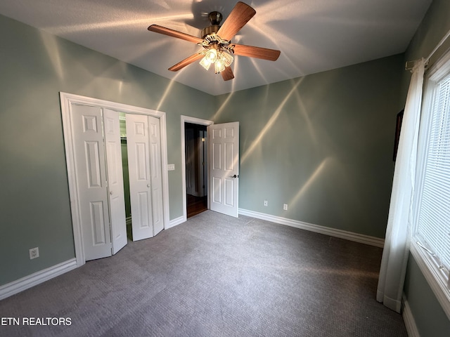 unfurnished bedroom featuring ceiling fan, carpet floors, a closet, and baseboards