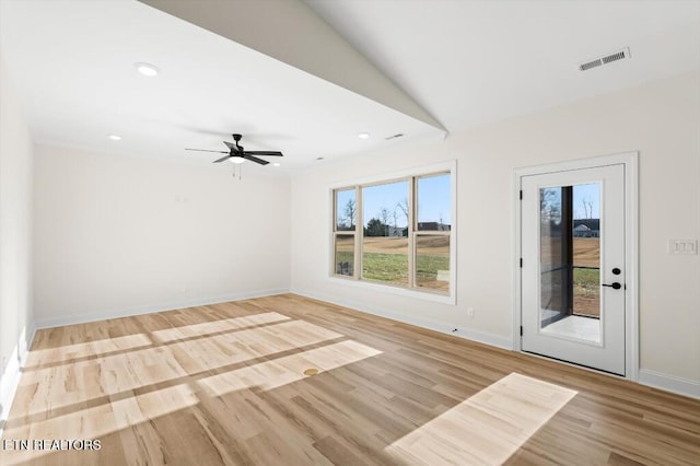 unfurnished room with ceiling fan, light hardwood / wood-style flooring, and vaulted ceiling