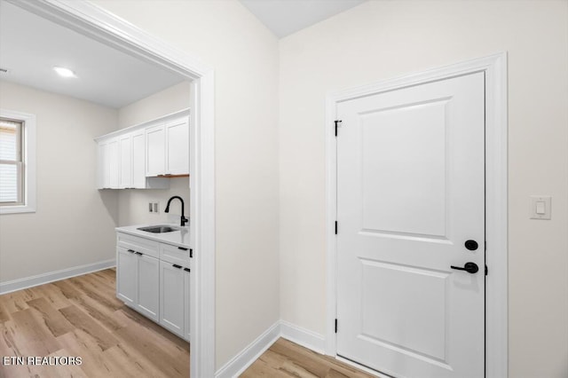 interior space featuring light wood-type flooring and sink