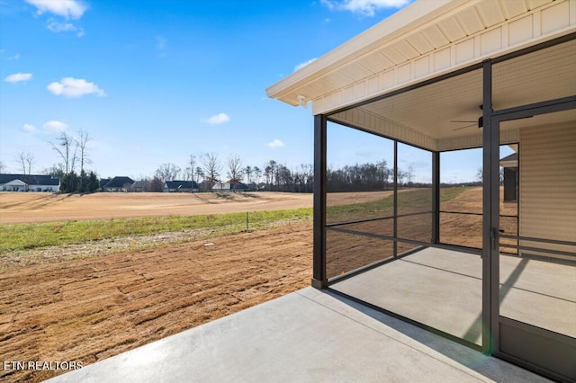 exterior space featuring a rural view and ceiling fan