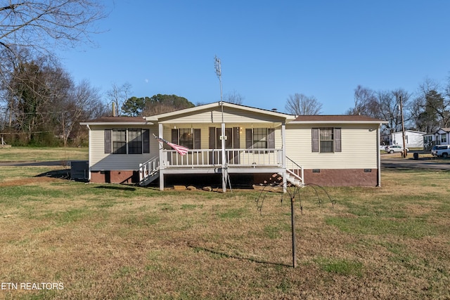 rear view of property with a yard, covered porch, and central air condition unit