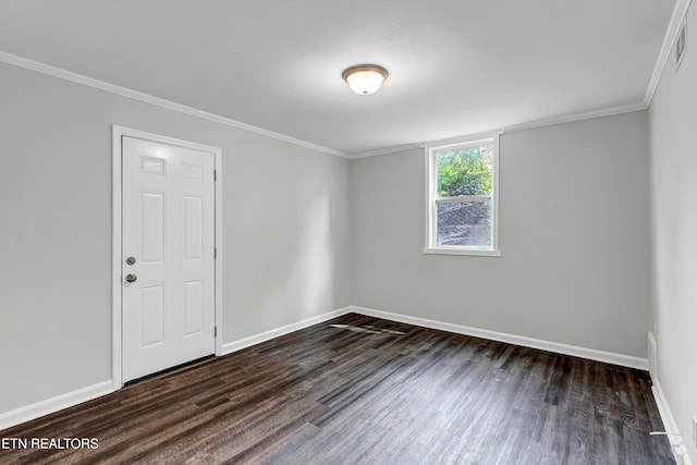 empty room with dark wood-type flooring and crown molding