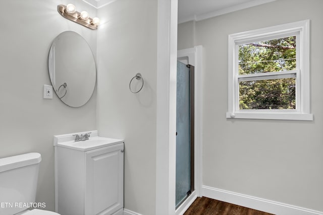 bathroom with a shower with shower door, vanity, wood-type flooring, and toilet