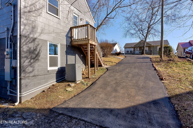 view of side of property with central AC unit and a garage