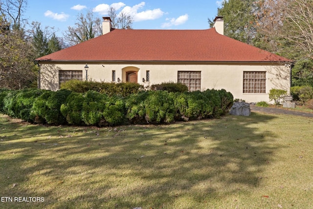 view of home's exterior with a yard