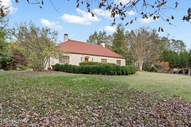 view of side of property with a yard