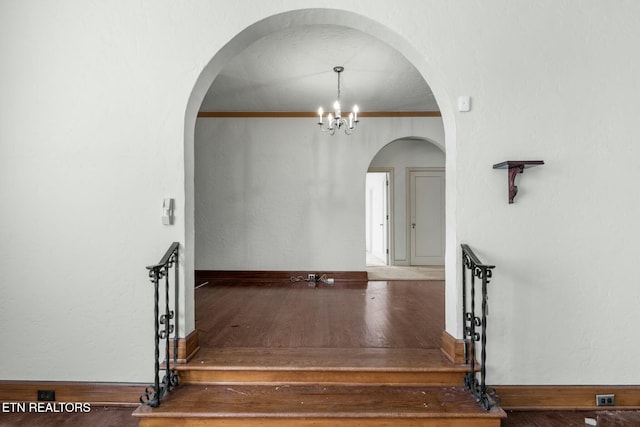 interior space with crown molding and a chandelier