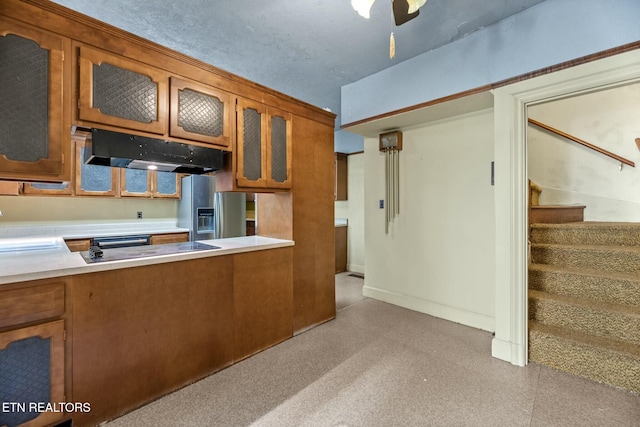 kitchen featuring stainless steel fridge with ice dispenser and black stovetop