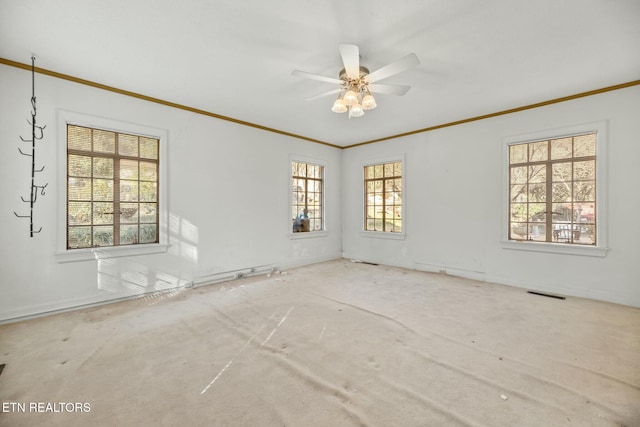 spare room with crown molding, ceiling fan, and carpet