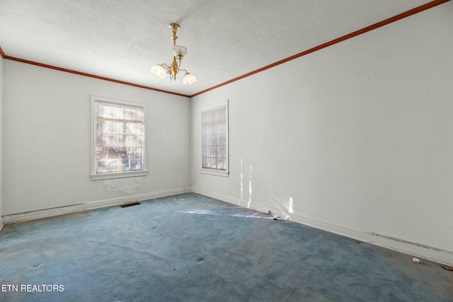 carpeted spare room with a notable chandelier and ornamental molding