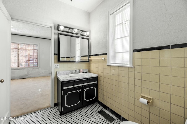 bathroom featuring tile walls and vanity