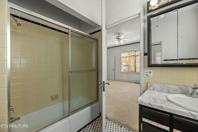 bathroom featuring vanity, shower / bath combination with glass door, and ceiling fan