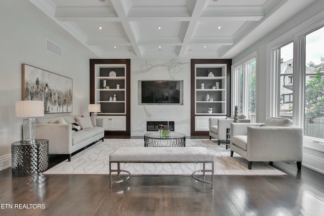 living room with a premium fireplace, coffered ceiling, wood-type flooring, built in shelves, and beamed ceiling