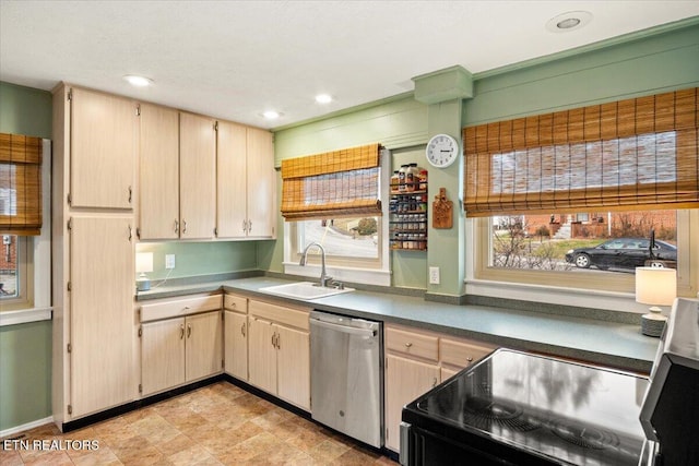 kitchen with stainless steel dishwasher, range with electric stovetop, light brown cabinetry, and sink