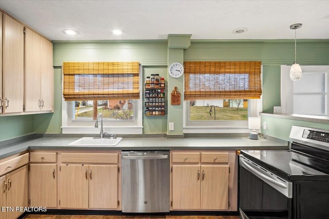 kitchen featuring a wealth of natural light, sink, hanging light fixtures, light brown cabinets, and stainless steel appliances