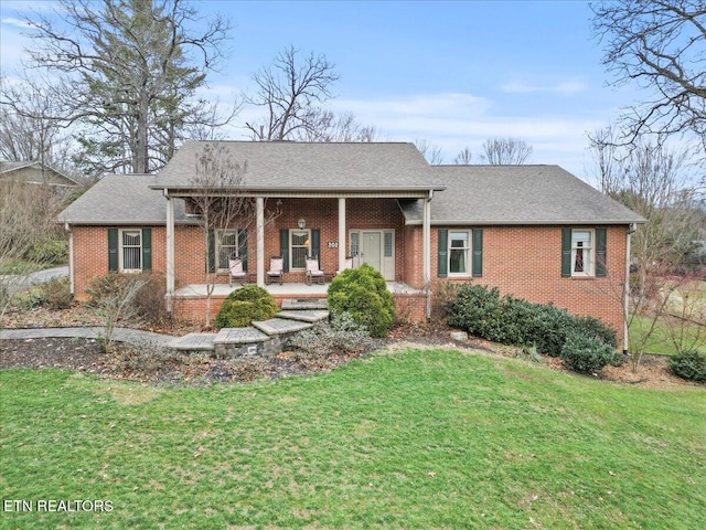 single story home with covered porch and a front yard