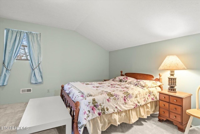 bedroom featuring light carpet and vaulted ceiling