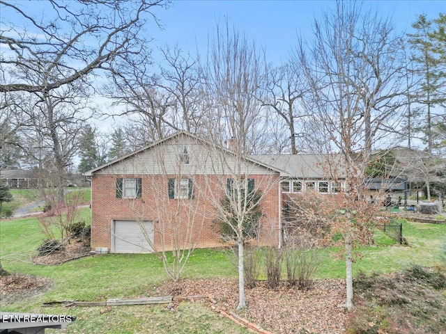 view of side of home featuring a garage and a lawn