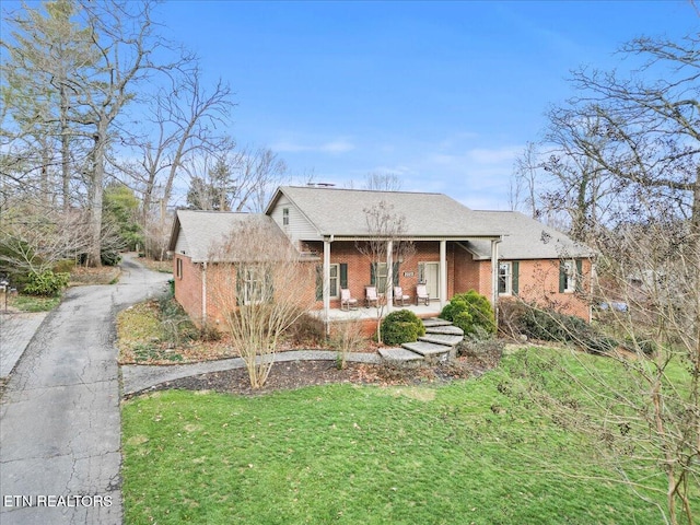 view of front of home with a front yard and covered porch