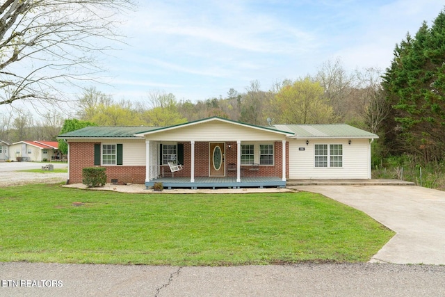 ranch-style home with covered porch and a front yard