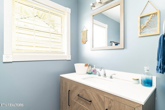 bathroom with vanity and a healthy amount of sunlight