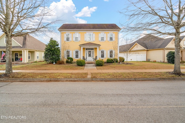 colonial home with a front yard