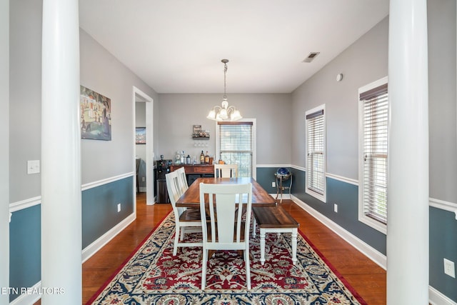 dining area with a chandelier, hardwood / wood-style flooring, and a wealth of natural light