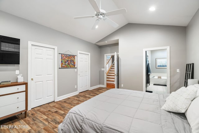 bedroom with vaulted ceiling, hardwood / wood-style flooring, ensuite bath, and ceiling fan