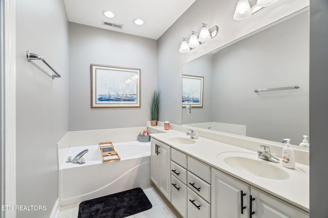 bathroom featuring tile patterned flooring, vanity, and a bathtub