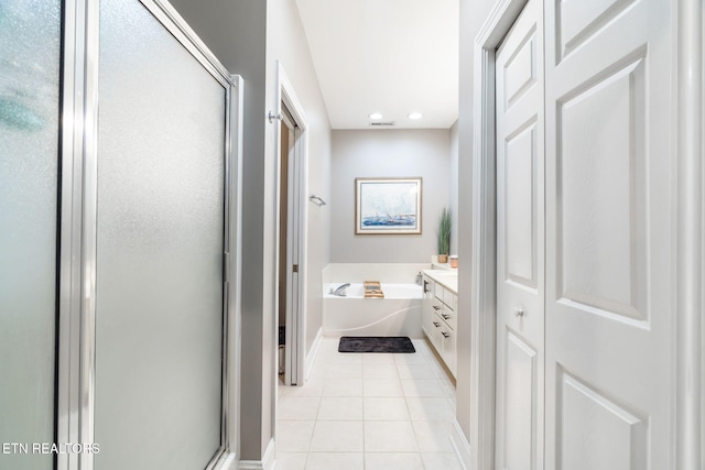 bathroom with tile patterned flooring, vanity, and shower with separate bathtub