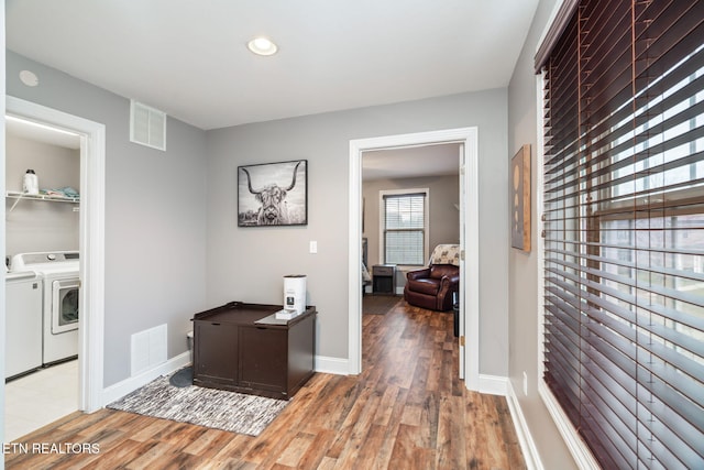 interior space featuring light wood-type flooring and washing machine and clothes dryer