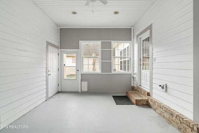 sunroom featuring ceiling fan