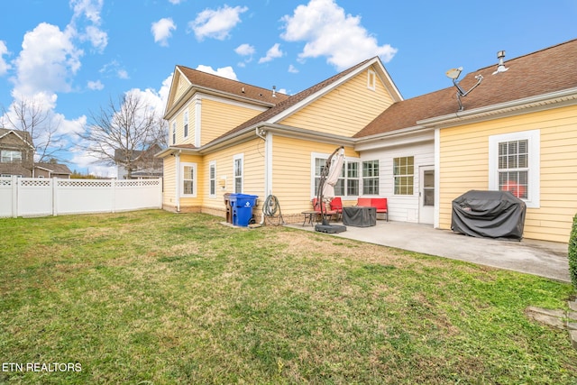 rear view of property featuring a yard and a patio