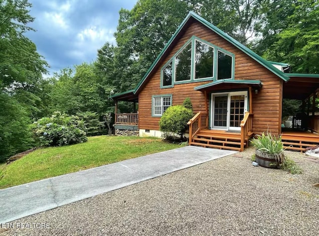 rear view of property featuring a lawn