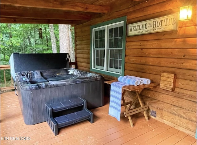 wooden terrace with a hot tub