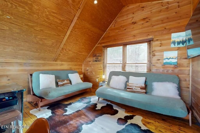 living area with hardwood / wood-style floors, lofted ceiling, wooden walls, and wooden ceiling