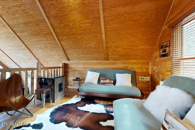 living area with hardwood / wood-style flooring, plenty of natural light, wooden walls, and wood ceiling