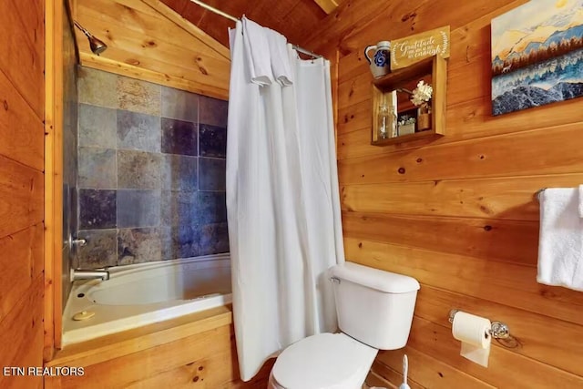 bathroom featuring shower / bath combo, toilet, lofted ceiling, and wooden walls