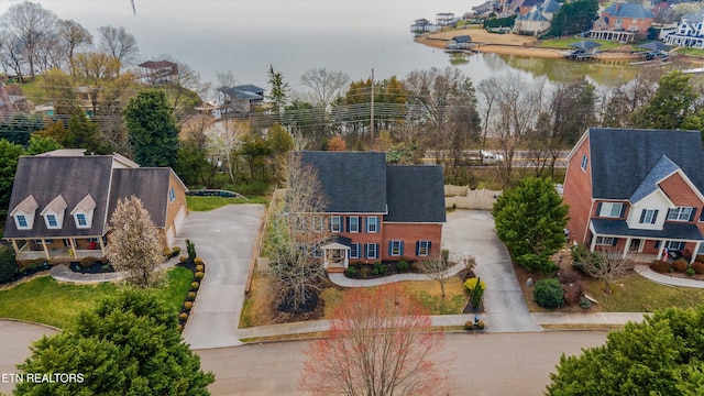 drone / aerial view featuring a residential view and a water view