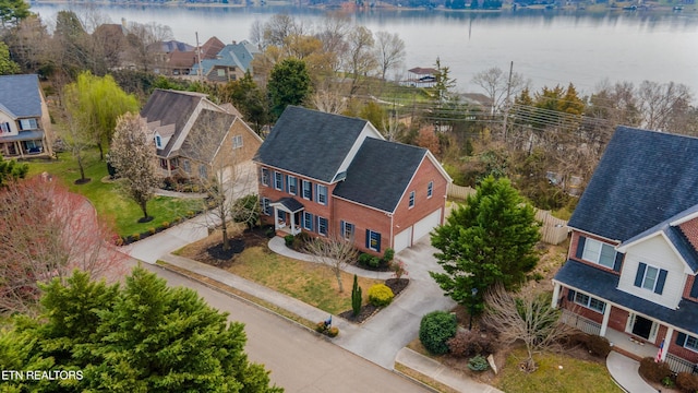 birds eye view of property featuring a residential view and a water view