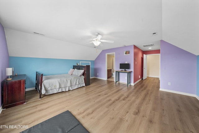 bedroom featuring visible vents, baseboards, and wood finished floors