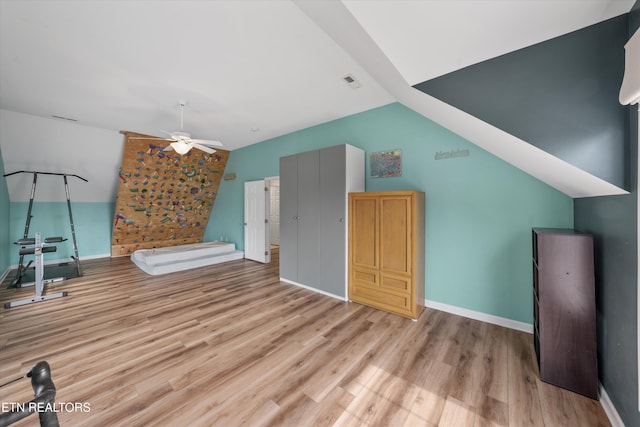 bonus room with visible vents, baseboards, light wood finished floors, lofted ceiling, and ceiling fan